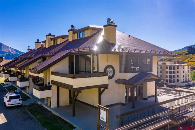 a view of a house with pool and chairs