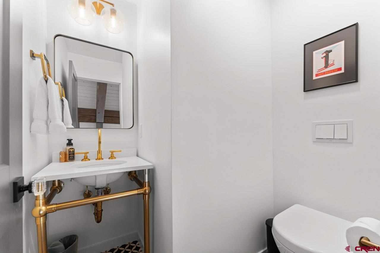14 Snowmass Road, Unit 308 Crested Butte, CO 81225 - Photo 32 of 40 a bathroom with a sink toilet and mirror