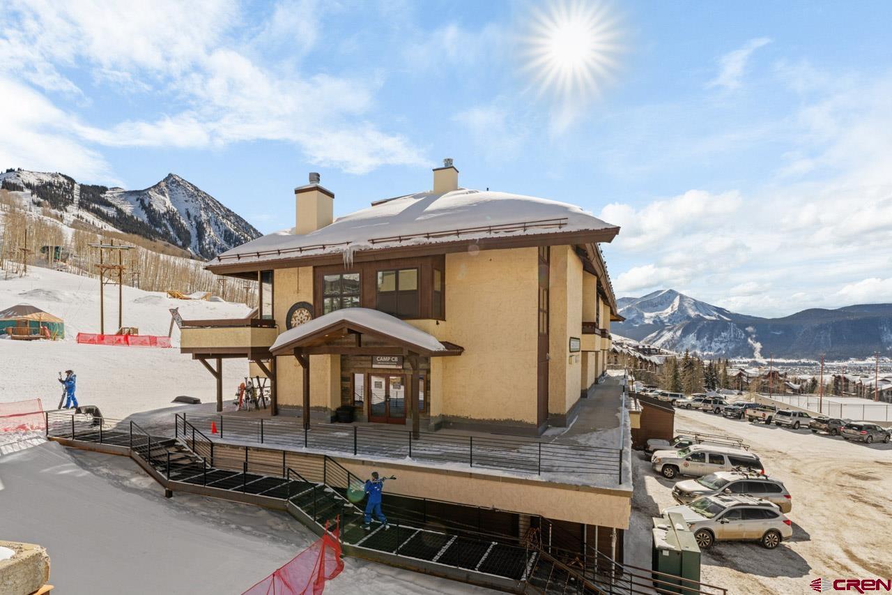14 Snowmass Road, Unit 308 Crested Butte, CO 81225 - Photo 37 of 40 a front view of a house with a yard