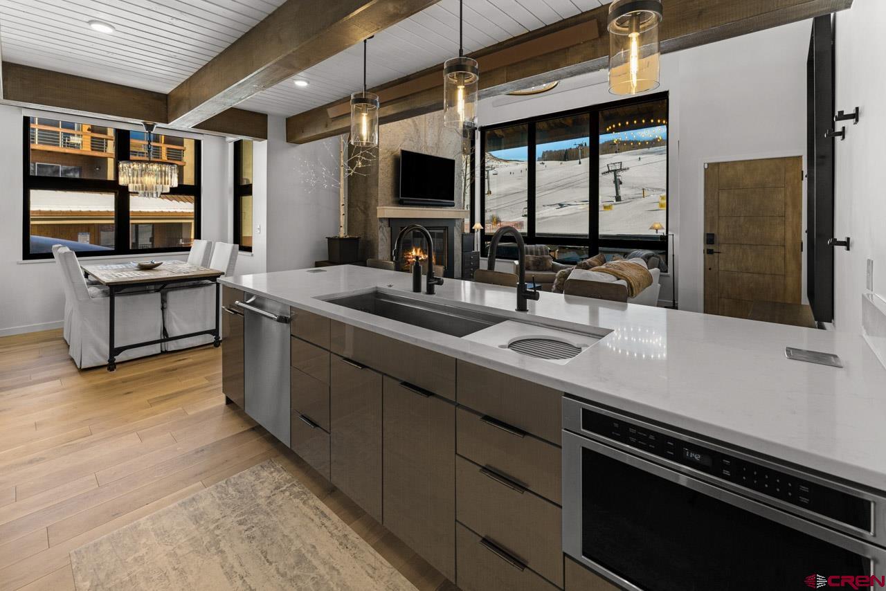 14 Snowmass Road, Unit 308 Crested Butte, CO 81225 - Photo 7 of 40 a kitchen with stainless steel appliances a sink and a stove