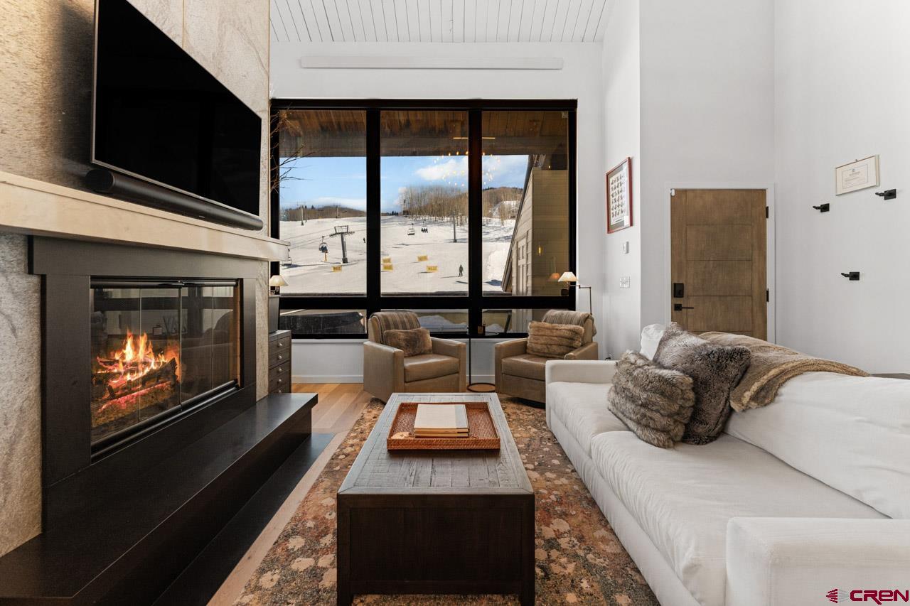 14 Snowmass Road, Unit 308 Crested Butte, CO 81225 - Photo 8 of 40 a living room with furniture fireplace and flat screen tv