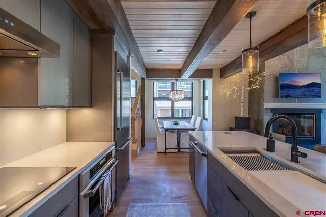 a kitchen with sink cabinets and wooden floor