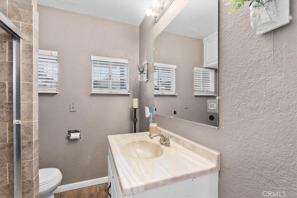 3974 5th Street Riverside, CA 92501 - Photo 25 of 45 a bathroom with a sink toilet vanity and mirror