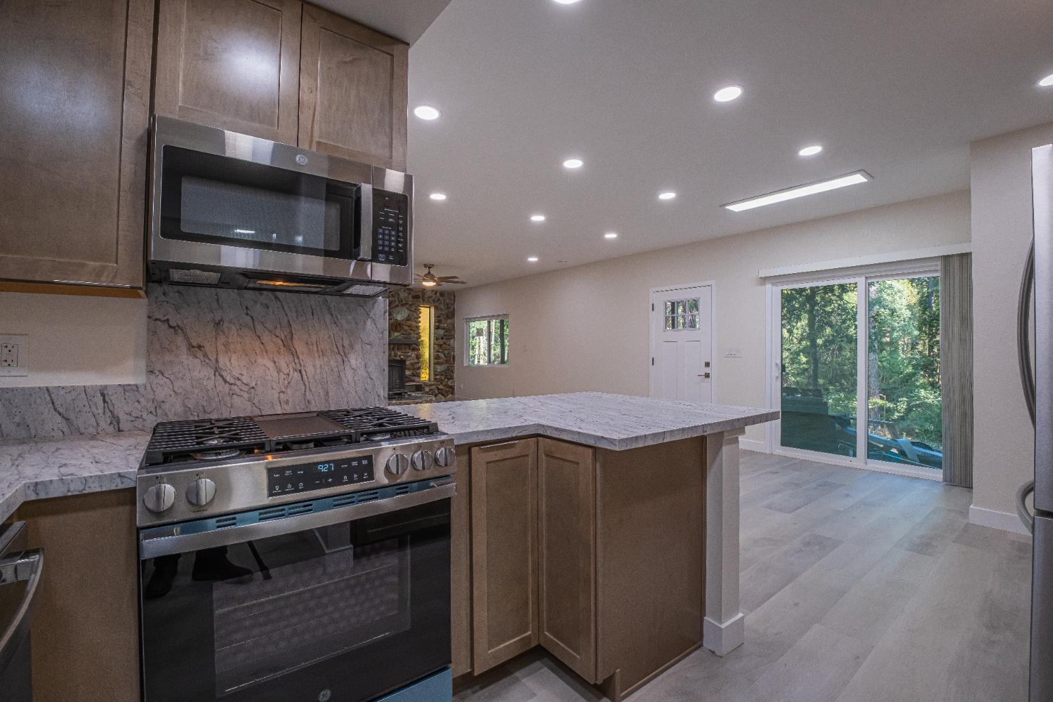 7701 Sly Park Road Placerville, CA 95667 - Photo 12 of 35 a kitchen with a stove and a microwave