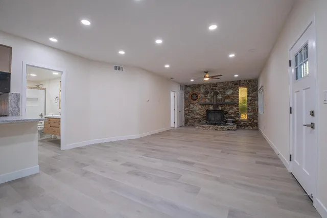 an empty room with furniture and a fireplace