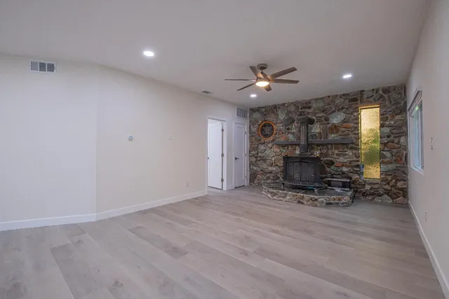 a view of an empty room with a ceiling fan