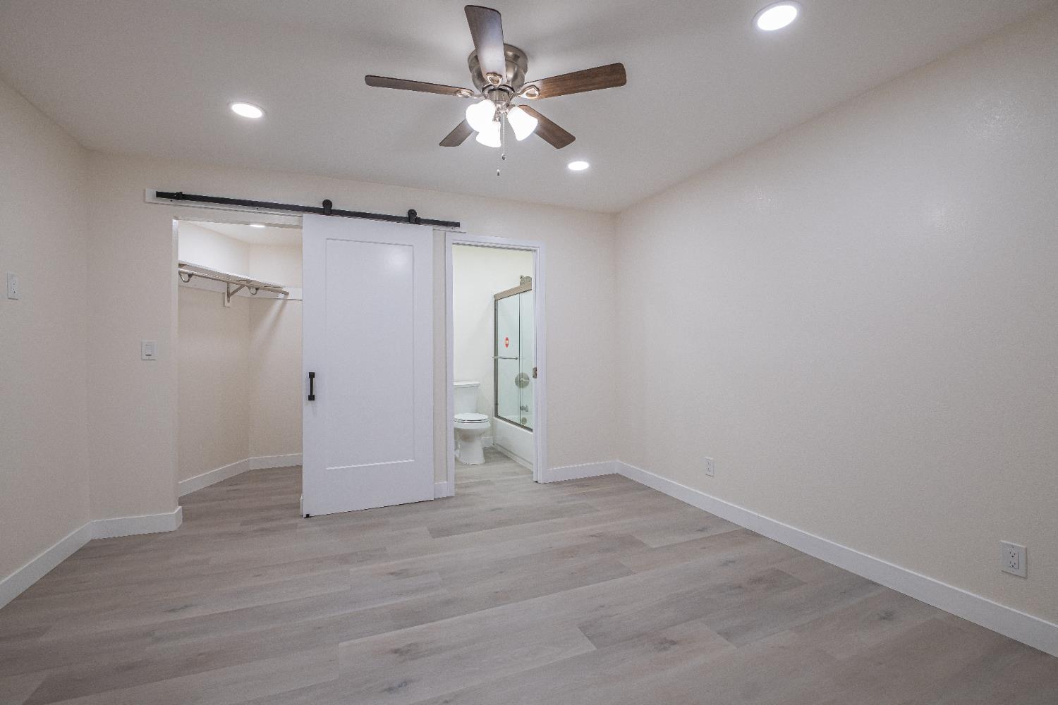 7701 Sly Park Road Placerville, CA 95667 - Photo 19 of 35 an empty room with wooden floor and ceiling fan