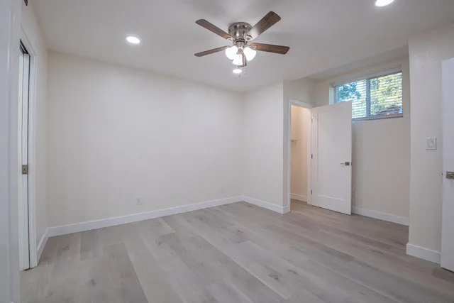 a bathroom with a toilet sink a mirror and shower