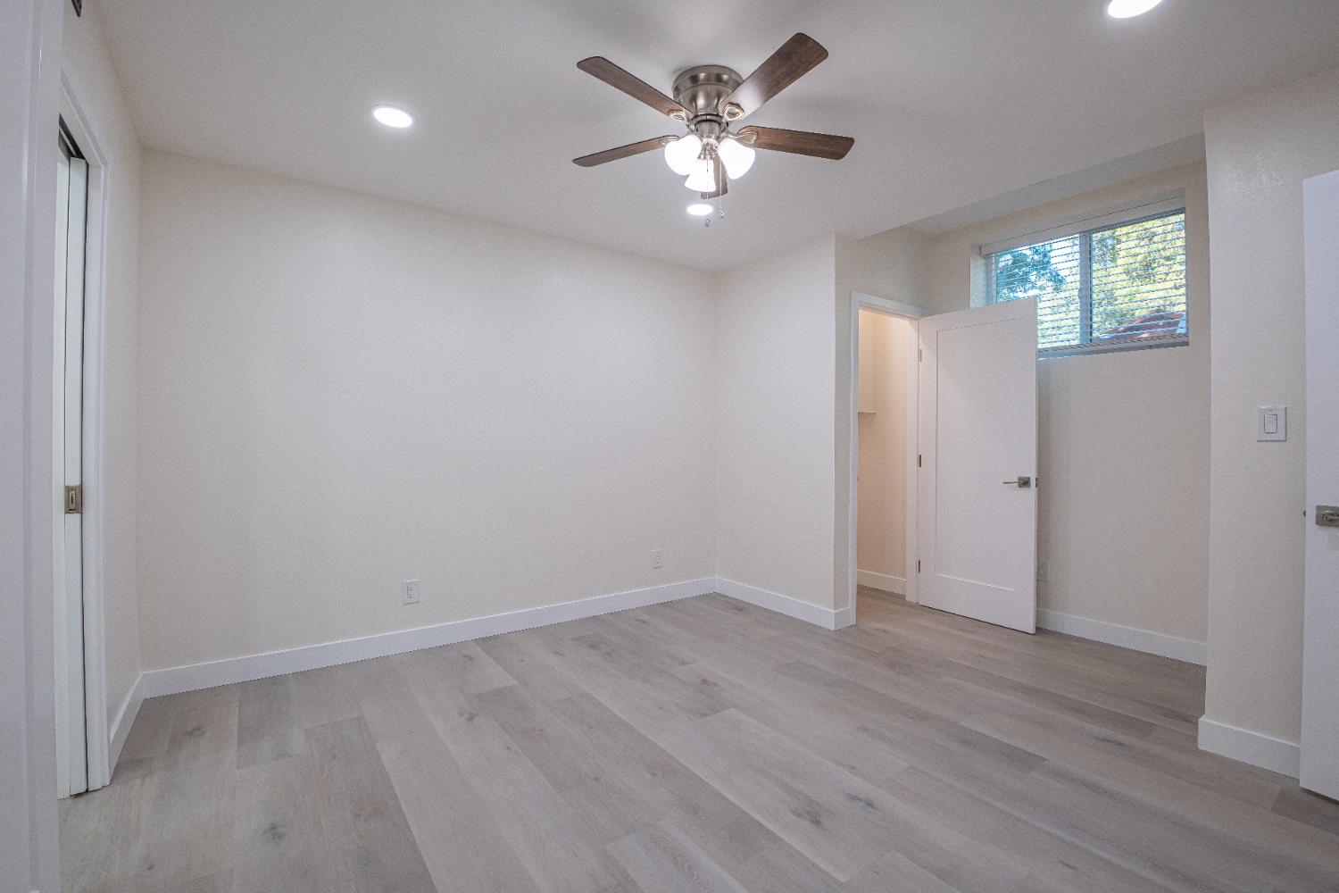 7701 Sly Park Road Placerville, CA 95667 - Photo 20 of 35 wooden floor in an empty room with a window