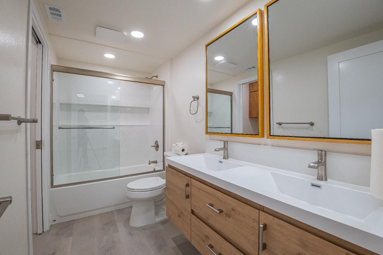 7701 Sly Park Road Placerville, CA 95667 - Photo 22 of 35 a bathroom with a double vanity sink toilet mirror and shower