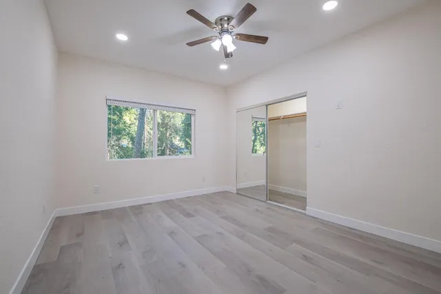 a view of an empty room with wooden floor