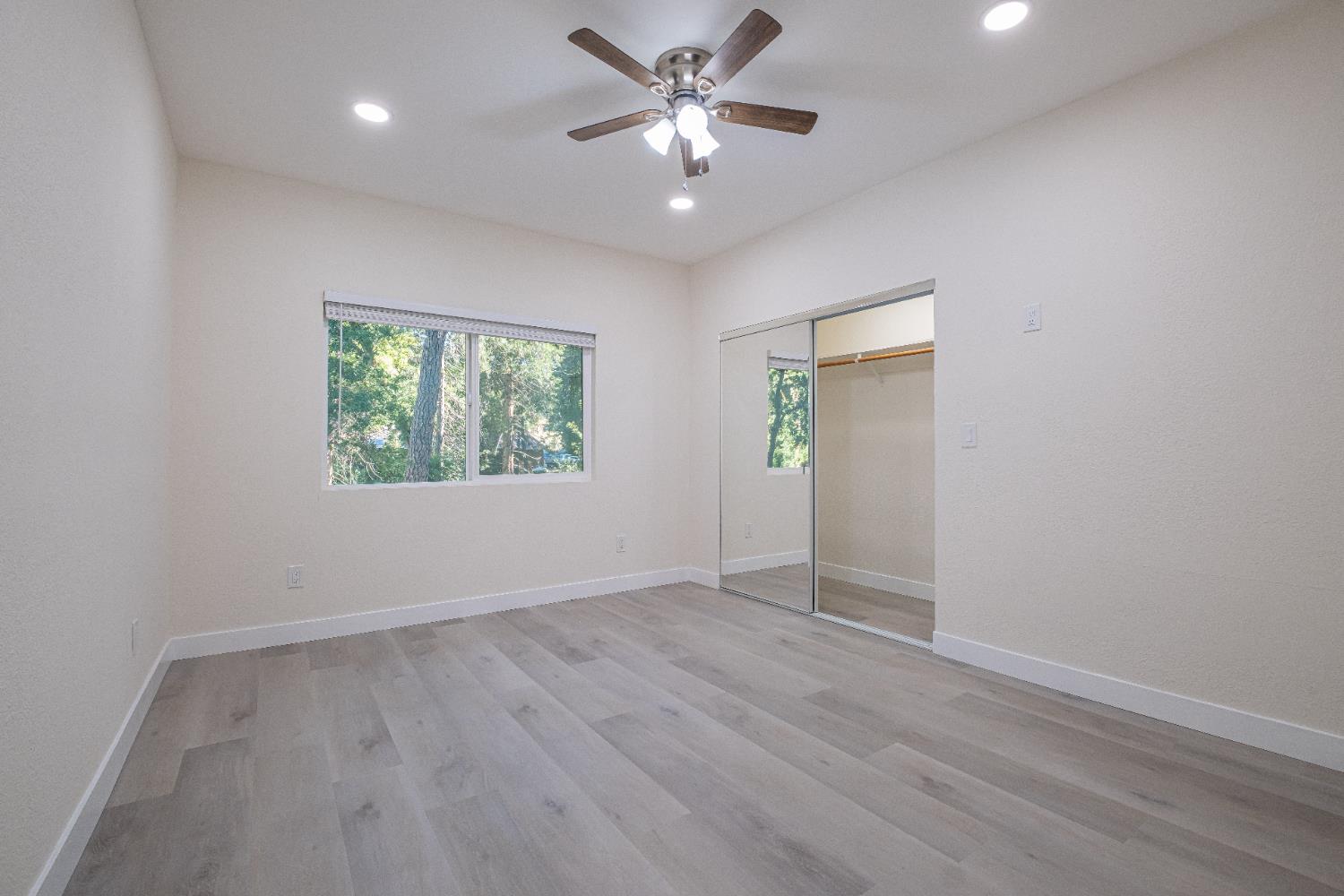 7701 Sly Park Road Placerville, CA 95667 - Photo 26 of 35 wooden floor in an empty room with a window