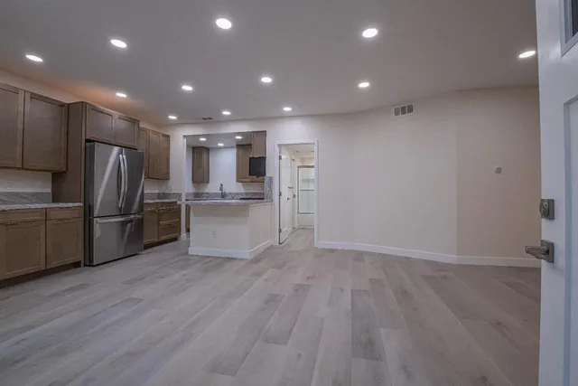 a view of kitchen with refrigerator and microwave