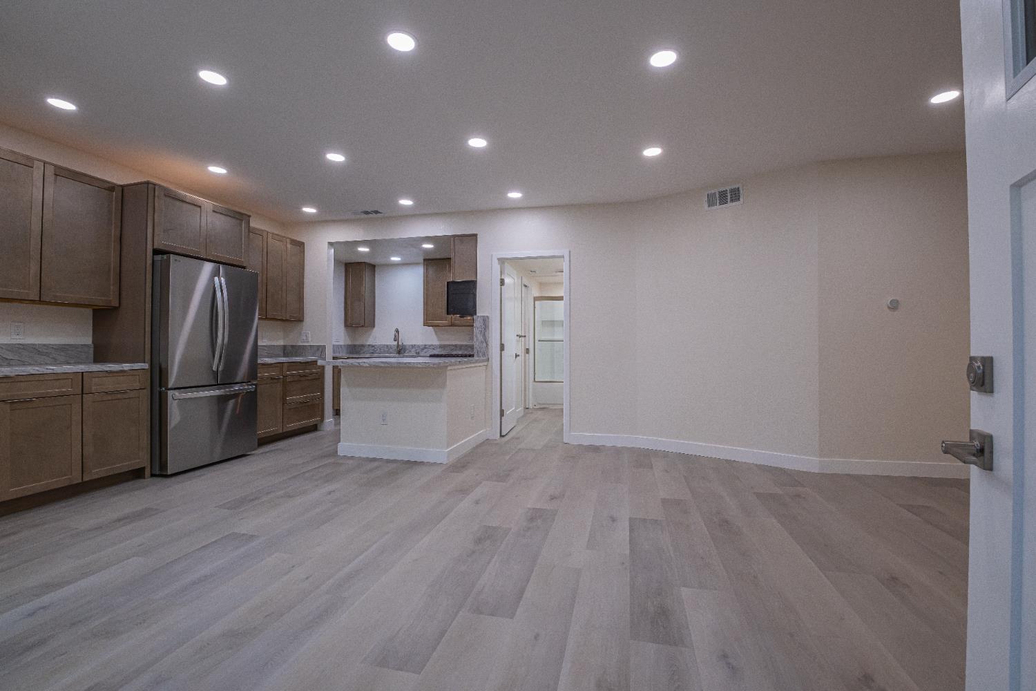 7701 Sly Park Road Placerville, CA 95667 - Photo 5 of 35 a view of kitchen with refrigerator microwave and wooden floor