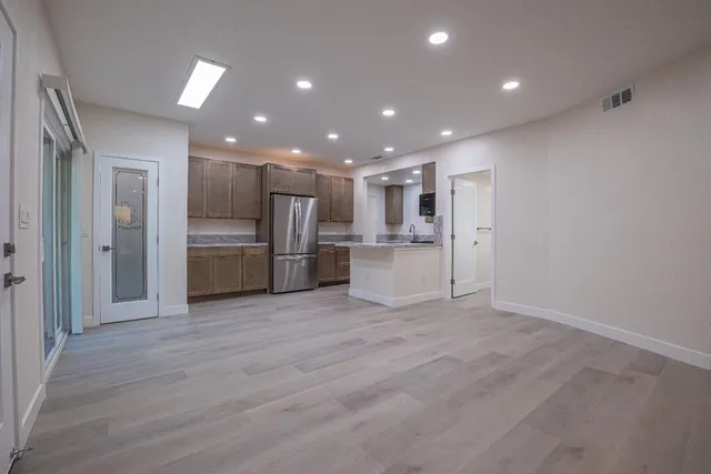 a kitchen with a refrigerator and a sink