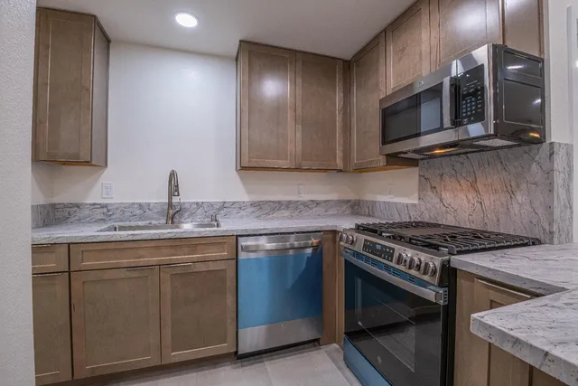 a kitchen with a sink and wooden floor