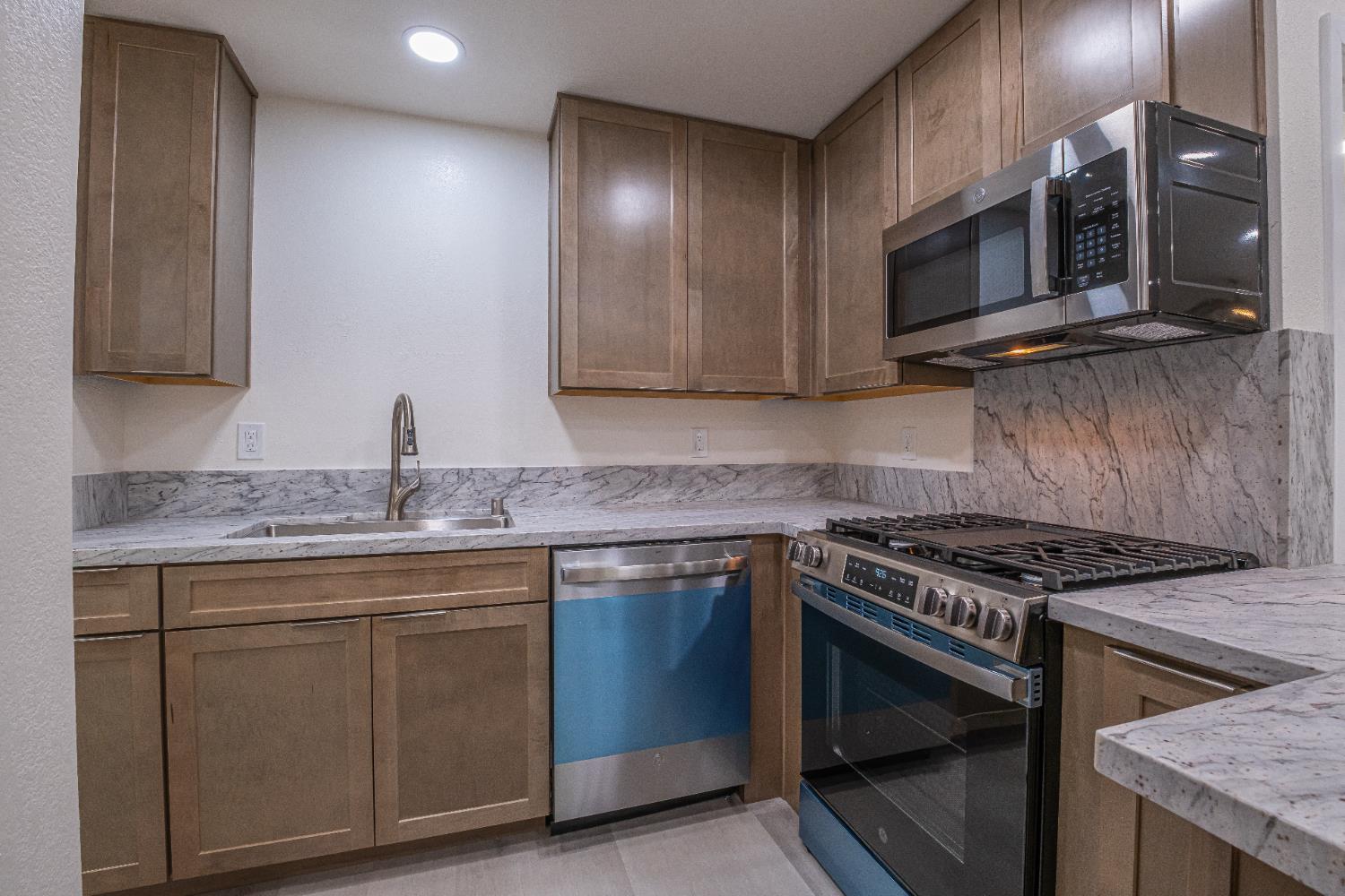 7701 Sly Park Road Placerville, CA 95667 - Photo 10 of 35 a kitchen with stainless steel appliances granite countertop a stove and a microwave