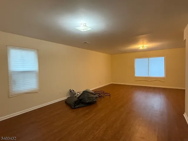 a big room with wooden floor and windows