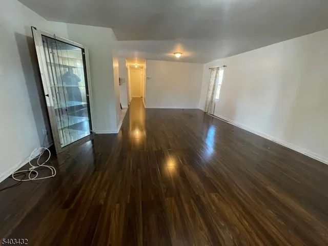 a view of a room with wooden floor and staircase