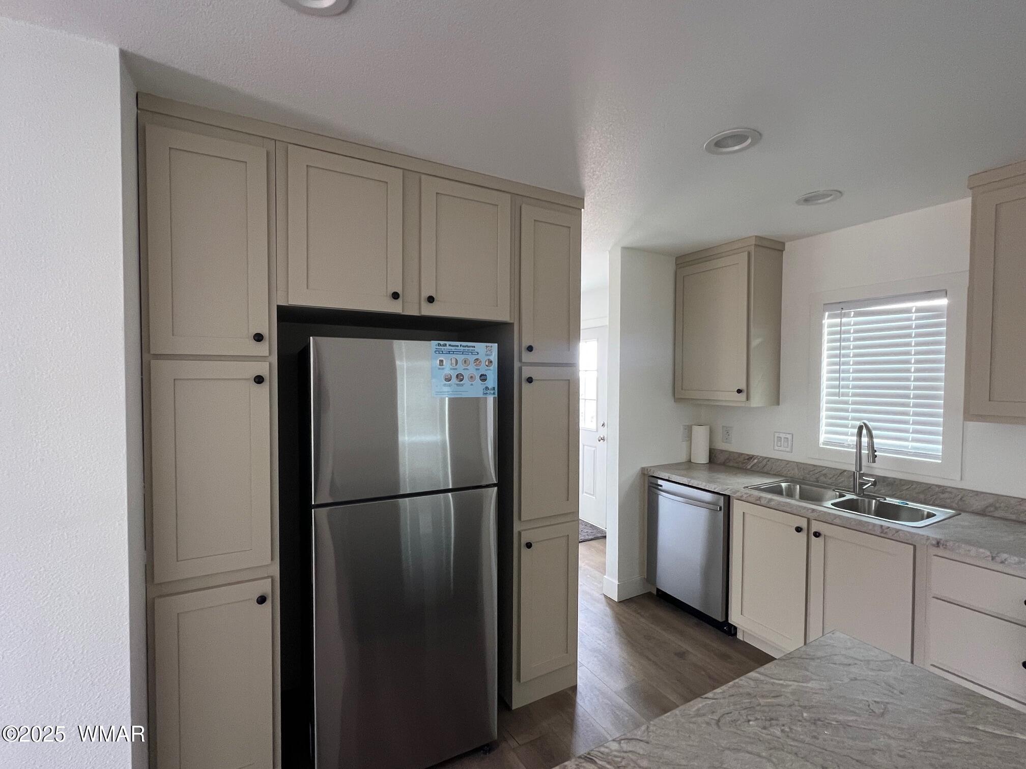 4129 Apache Road Snowflake, AZ 85937 - Photo 13 of 48 a kitchen with stainless steel appliances granite countertop a refrigerator a sink a stove a microwave and white cabinets