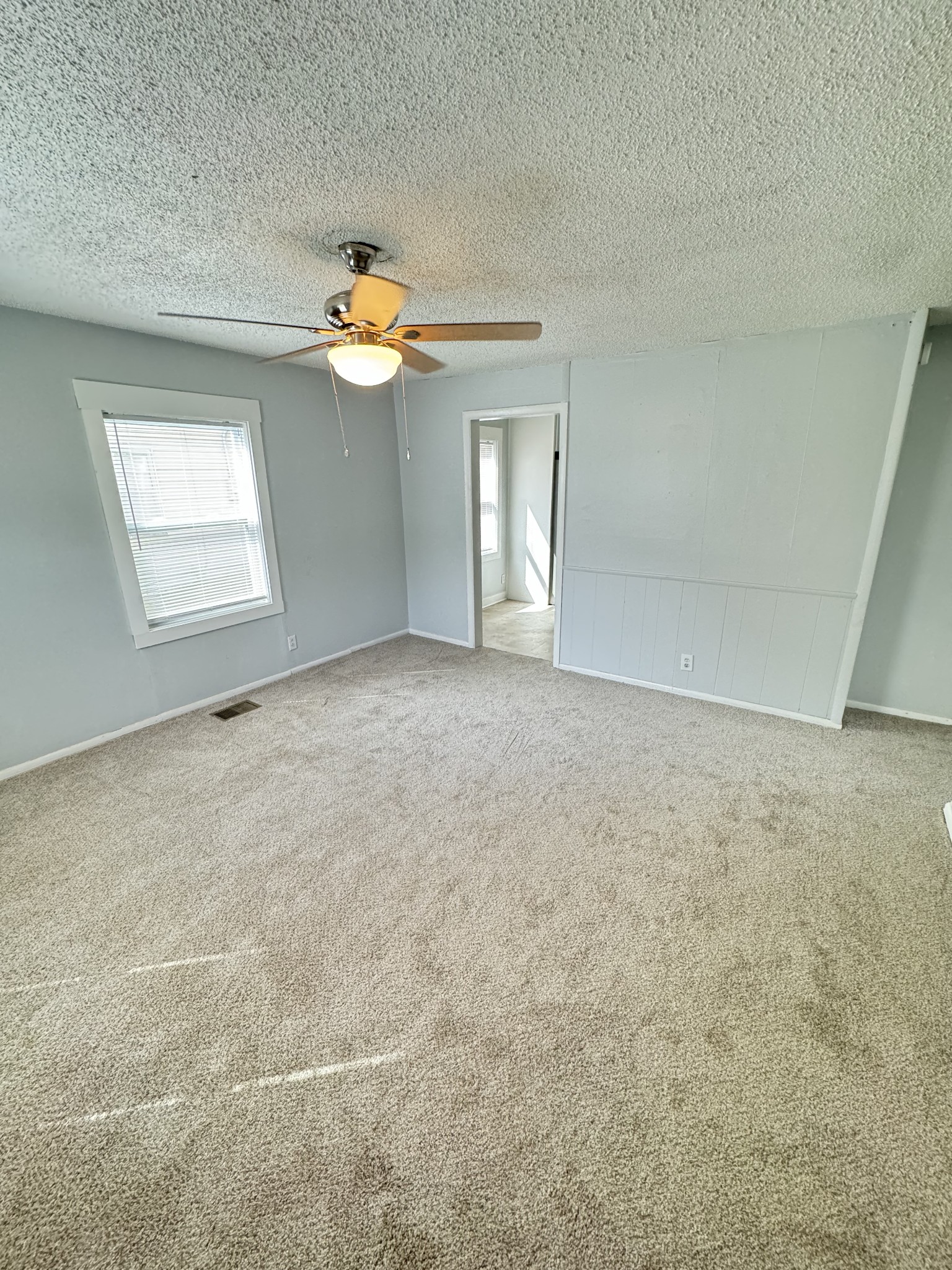 1104 Riverside Drive Murfreesboro, TN 37129 - Photo 2 of 8 an empty room with a window and chandelier fan