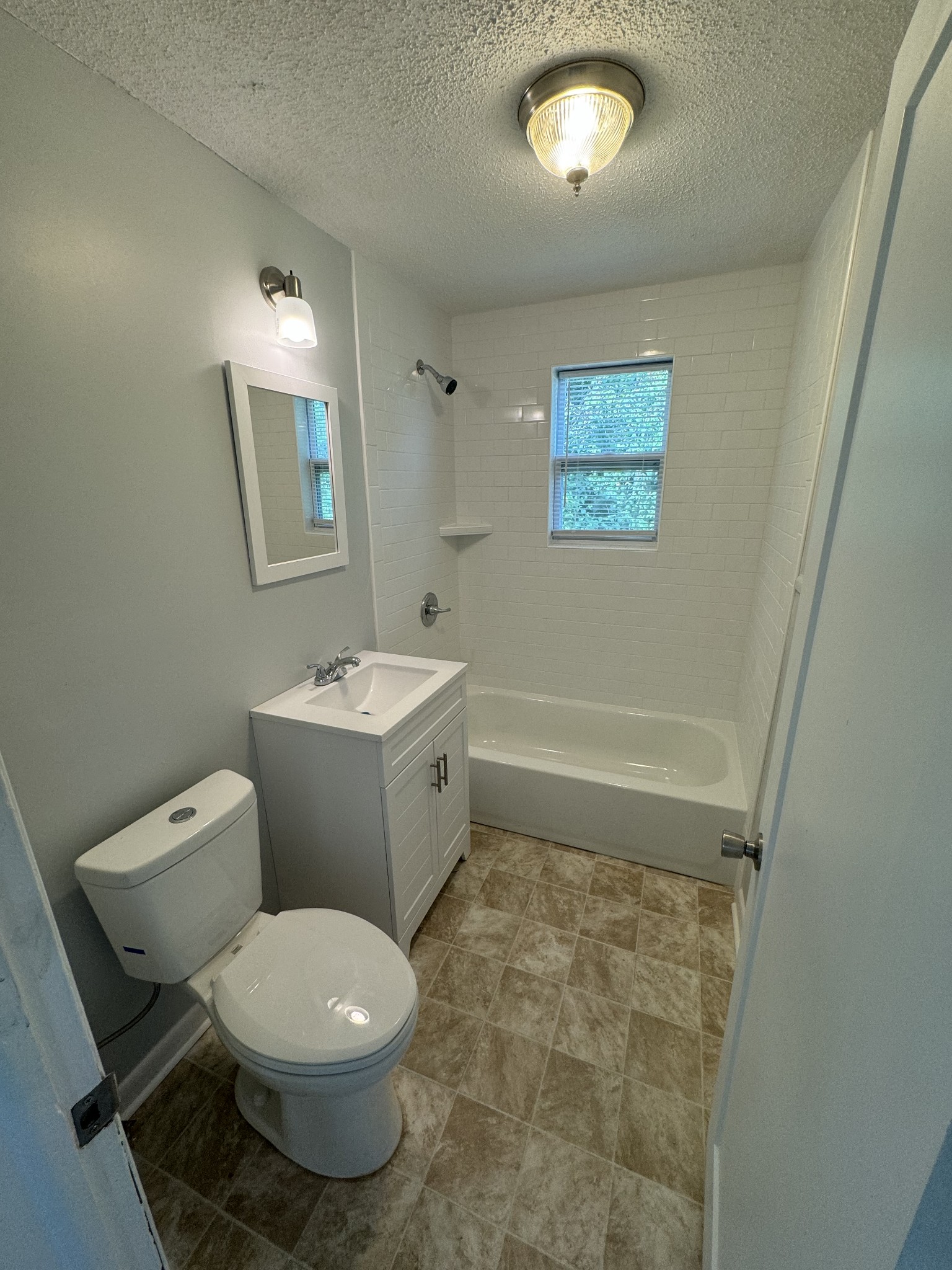 1104 Riverside Drive Murfreesboro, TN 37129 - Photo 6 of 8 a white toilet sitting next to a bathroom sink