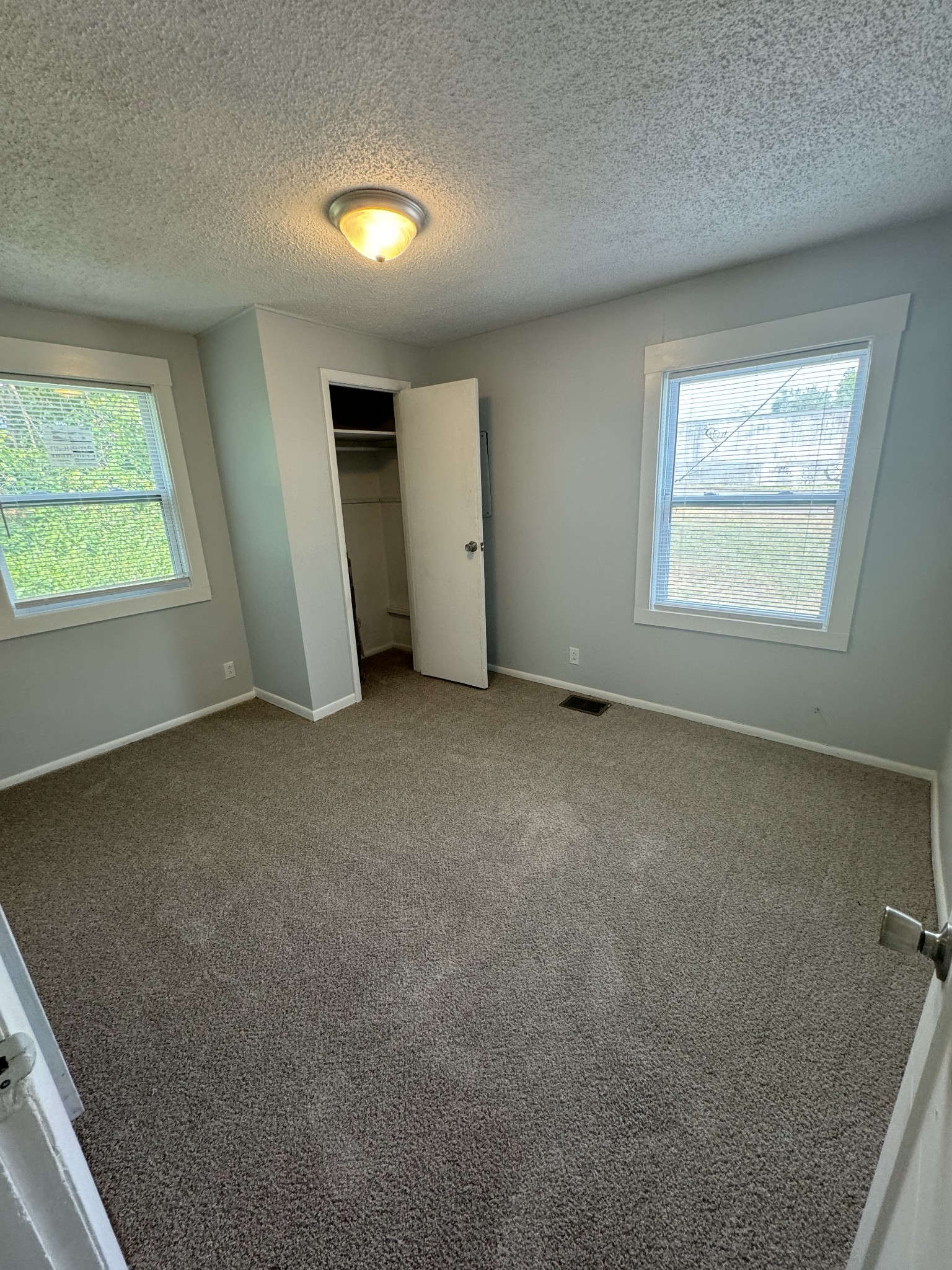 1104 Riverside Drive Murfreesboro, TN 37129 - Photo 7 of 8 an empty room with a empty space and windows