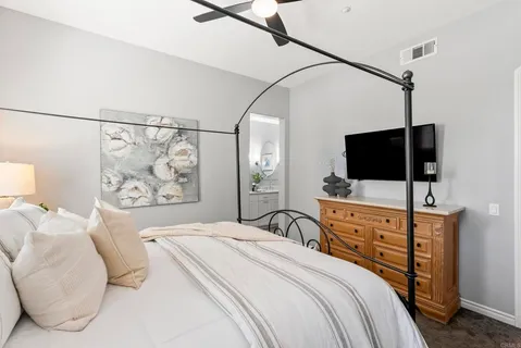 a spacious bathroom with a double vanity sink a mirror and a bathtub