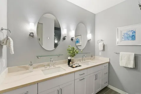 a large bathroom with a tub sink shower and mirror