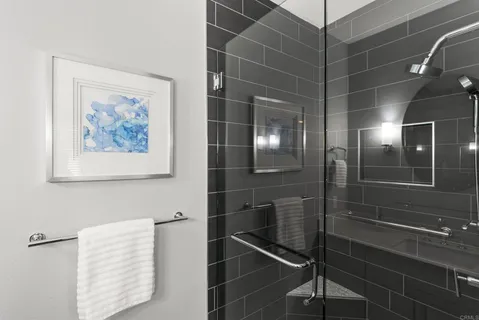 a spacious bathroom with a double vanity sink a mirror a bathtub and window