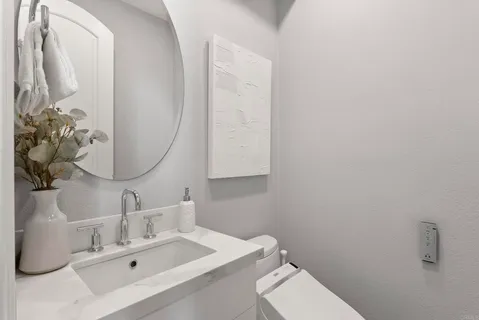 a bathroom with a tub sink and mirror