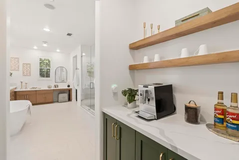 a living room with furniture a potted plant and a window