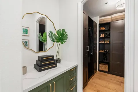 a living room with furniture a flat screen tv and a window
