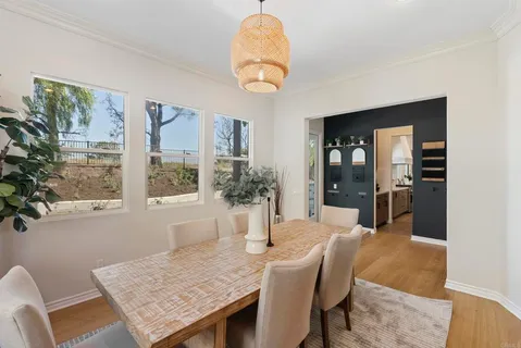 a dining table with chairs and window