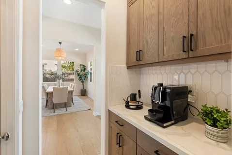 a living room with furniture a fireplace and a large window