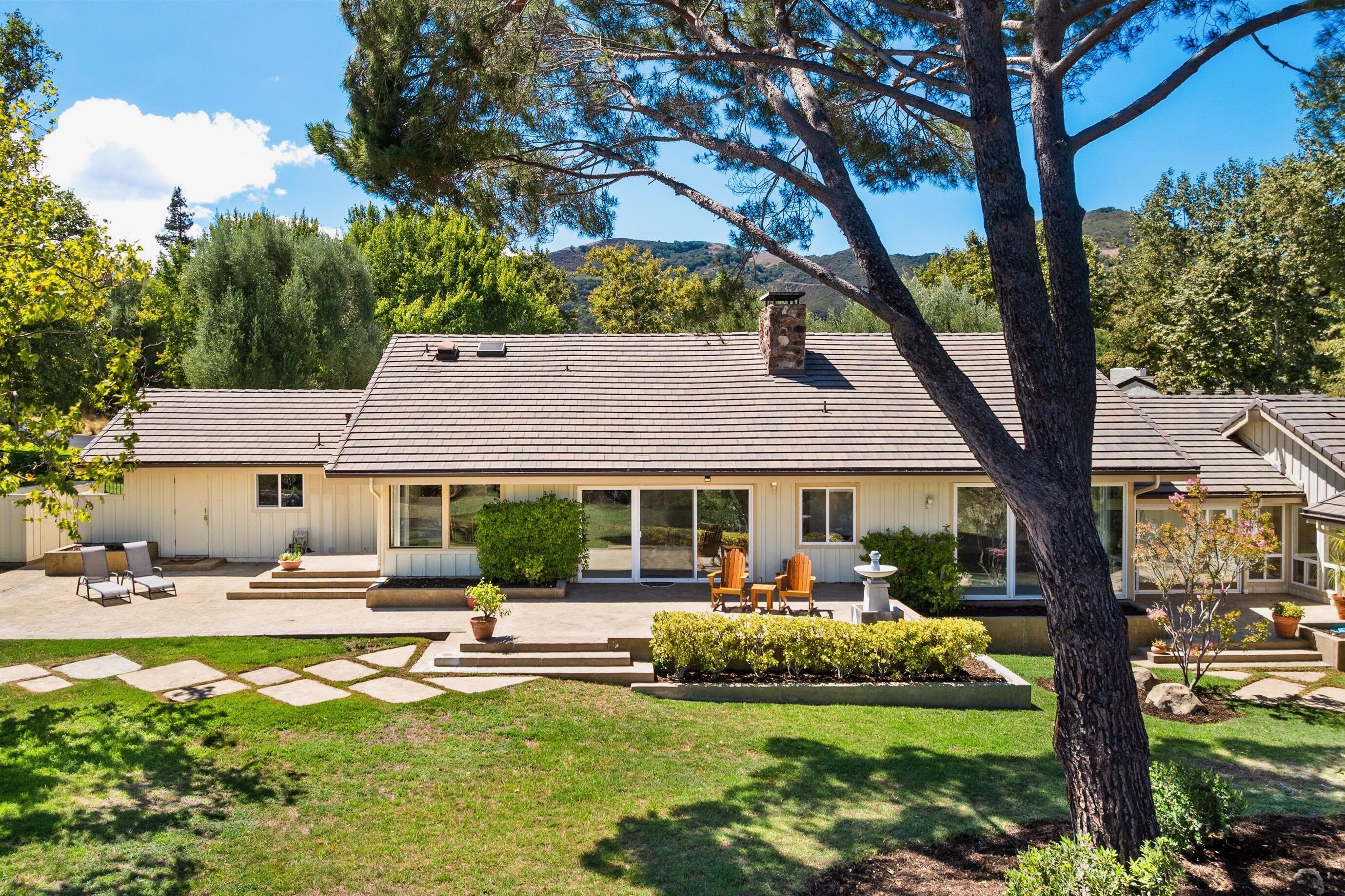 a front view of a house with garden and patio