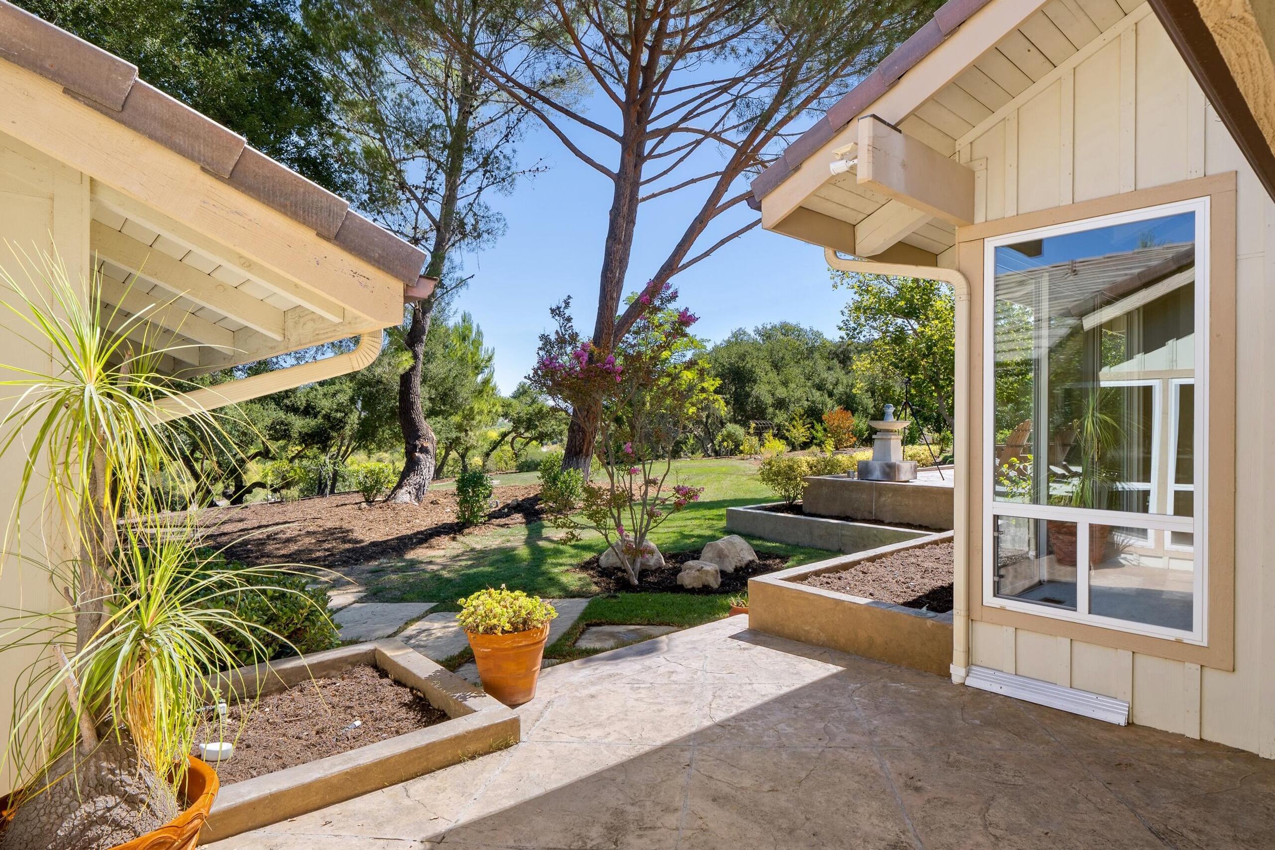 166 Rancho Alisal Drive Solvang, CA 93463 - Photo 16 of 24 a view of a patio with table and chairs and potted plants