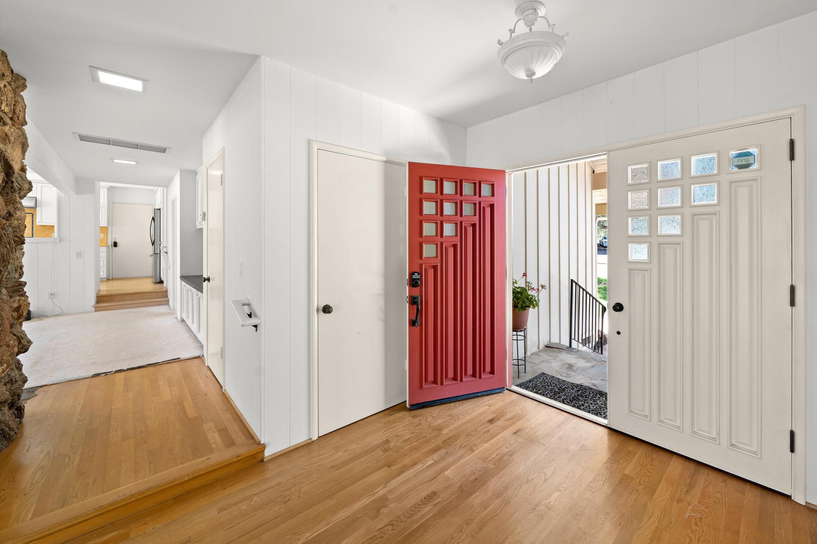 166 Rancho Alisal Drive Solvang, CA 93463 - Photo 3 of 24 a view of a hallway with wooden floor and a bathroom