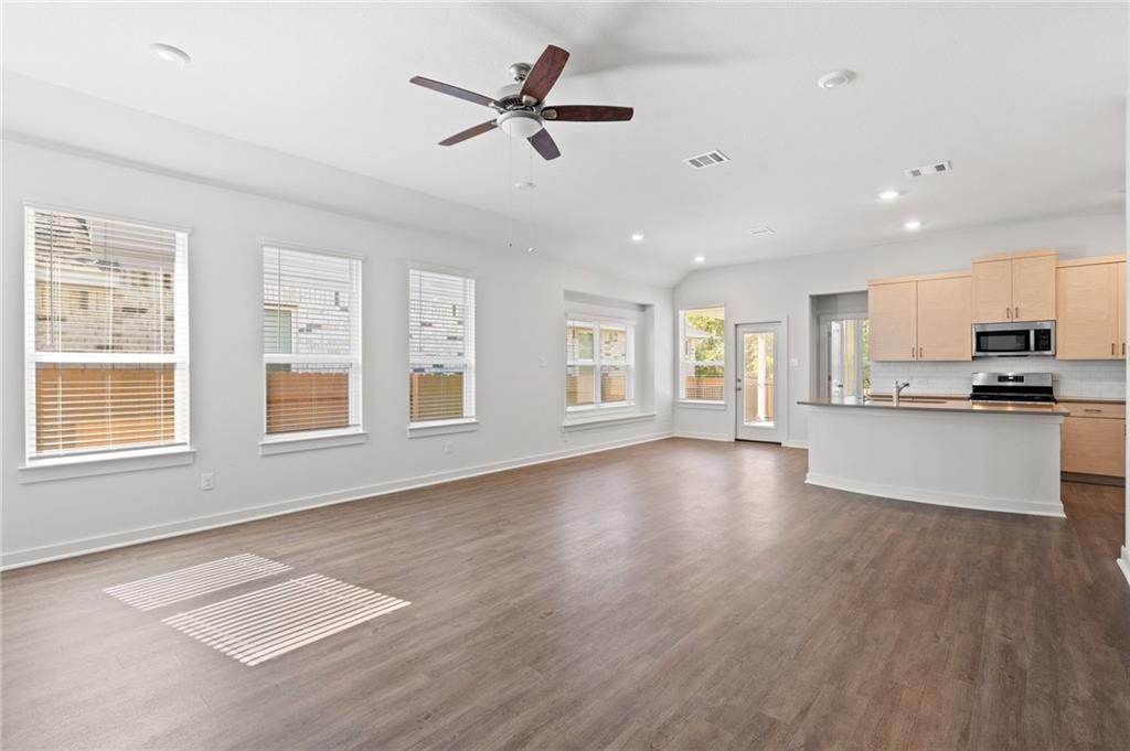 1012 Paddock Lane Georgetown, TX 78626 - Photo 15 of 15 An open floorplan living area showcases rich hardwood flooring and abundant natural light.
