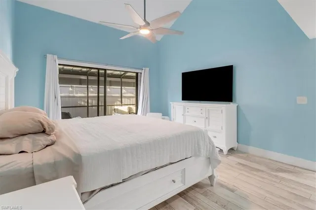 a bedroom with a large bed and a large window