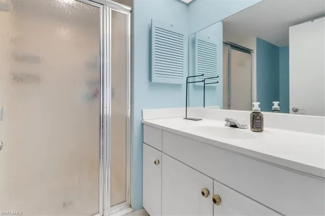 a bathroom with a granite countertop toilet sink and mirror