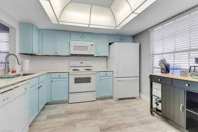 a kitchen with a white stove top oven and refrigerator