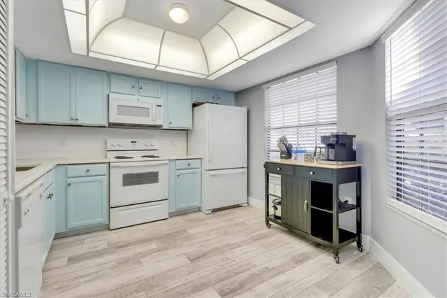 a kitchen with a stove a sink and a refrigerator