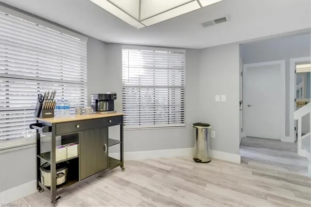 a view of workspace with furniture and window