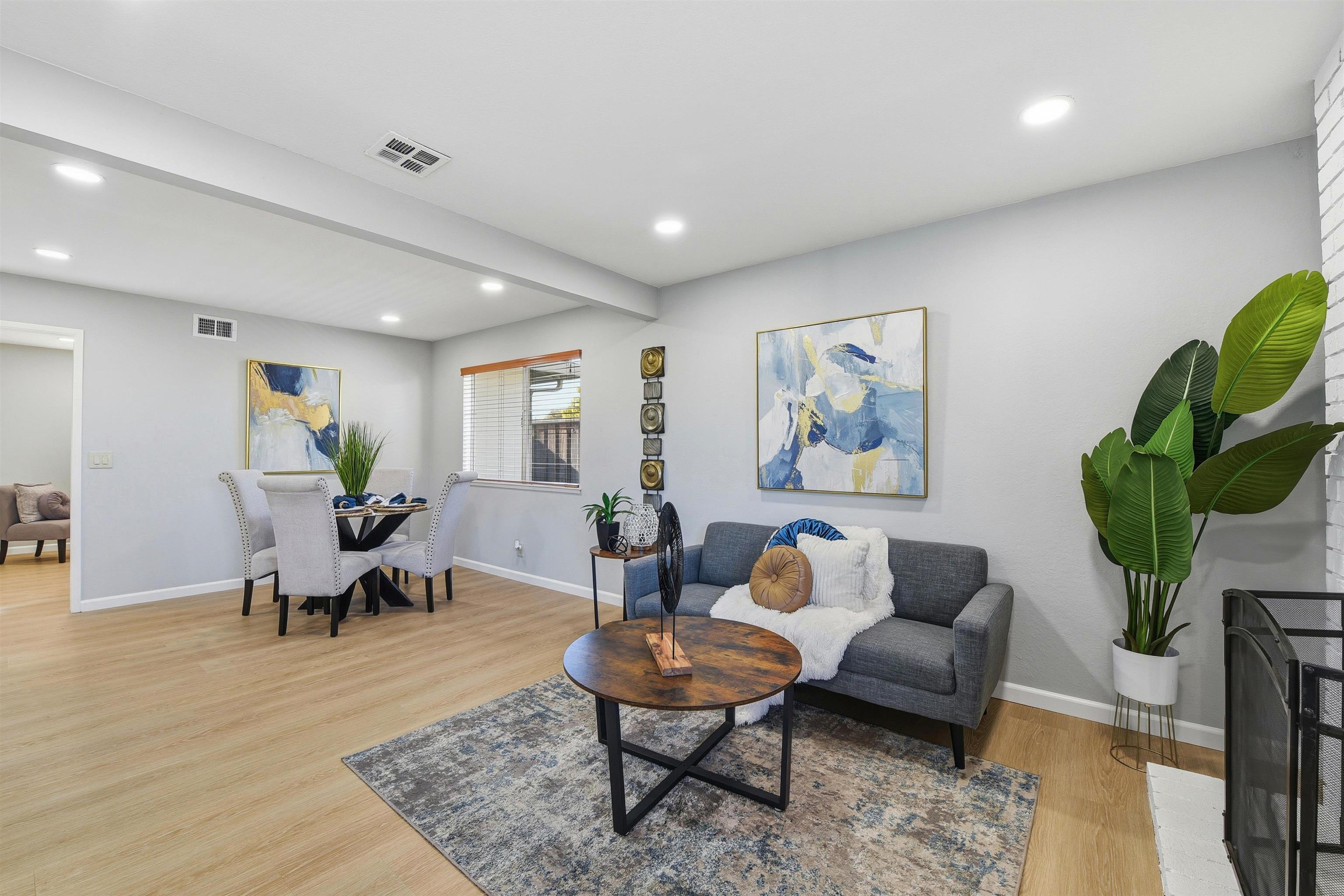 37768 Rockspray Street Newark, CA 94560 - Photo 16 of 34 a living room with furniture a glass table and a potted plant