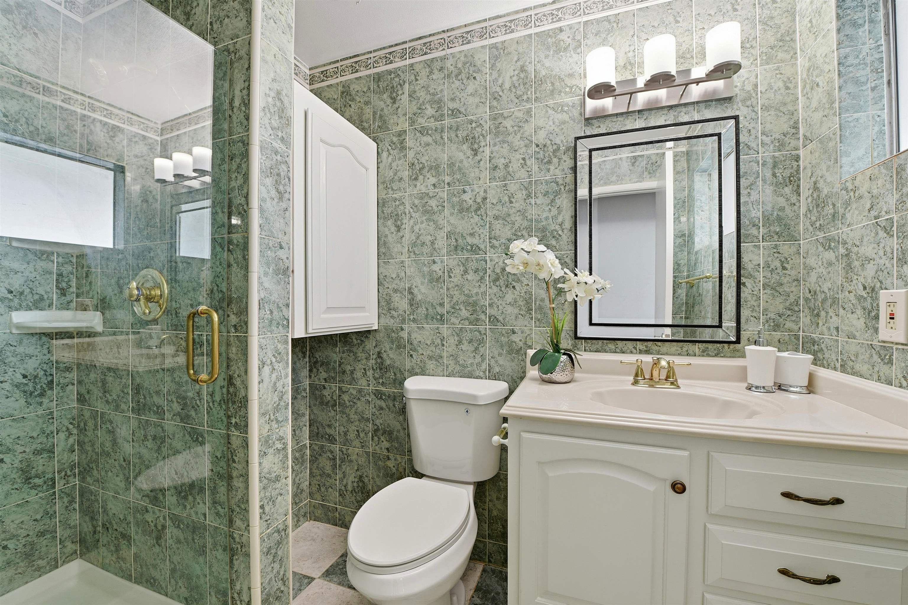 37768 Rockspray Street Newark, CA 94560 - Photo 22 of 34 a bathroom with a toilet a sink a mirror and shower