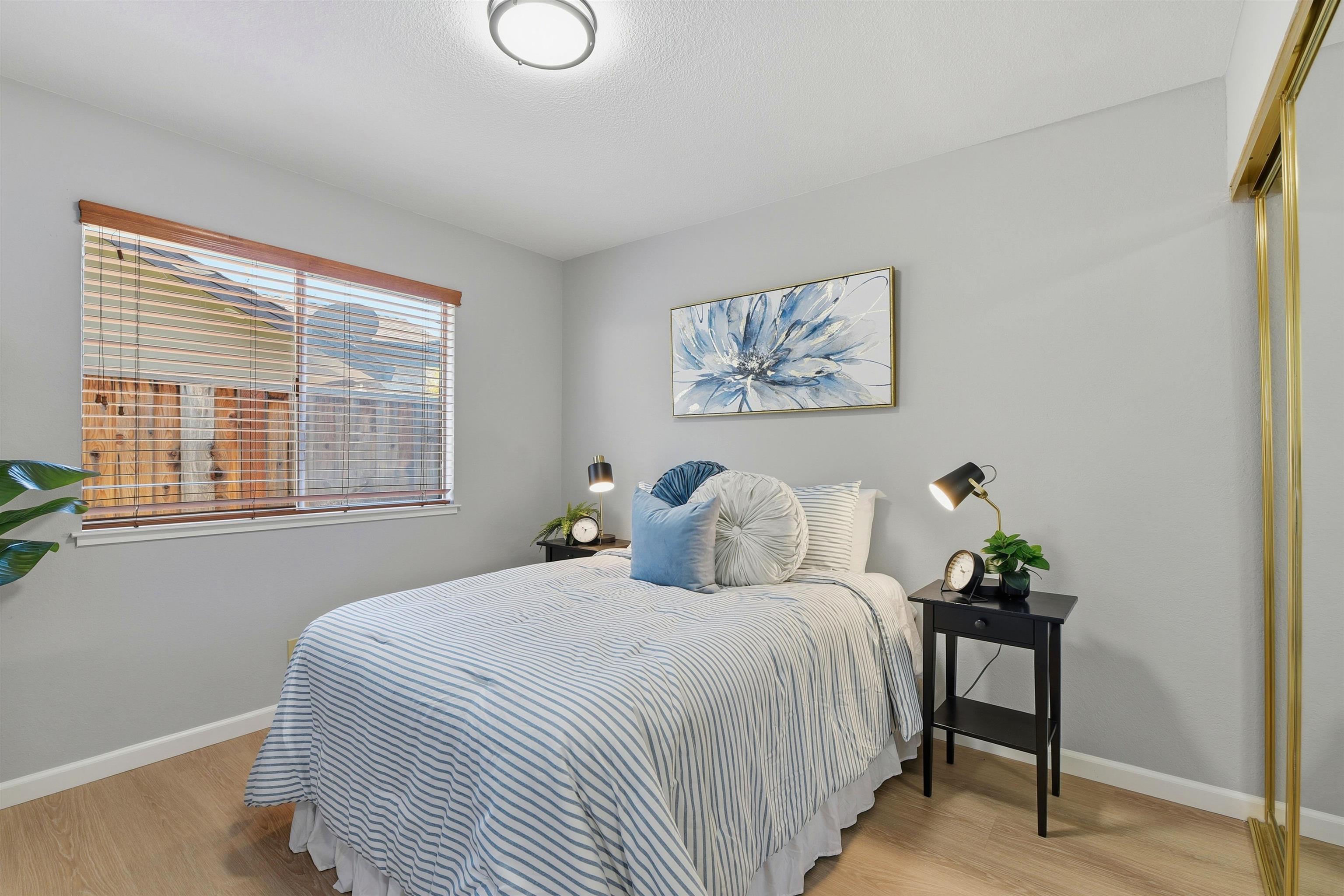 37768 Rockspray Street Newark, CA 94560 - Photo 25 of 34 a bedroom with a bed and a painting on the wall
