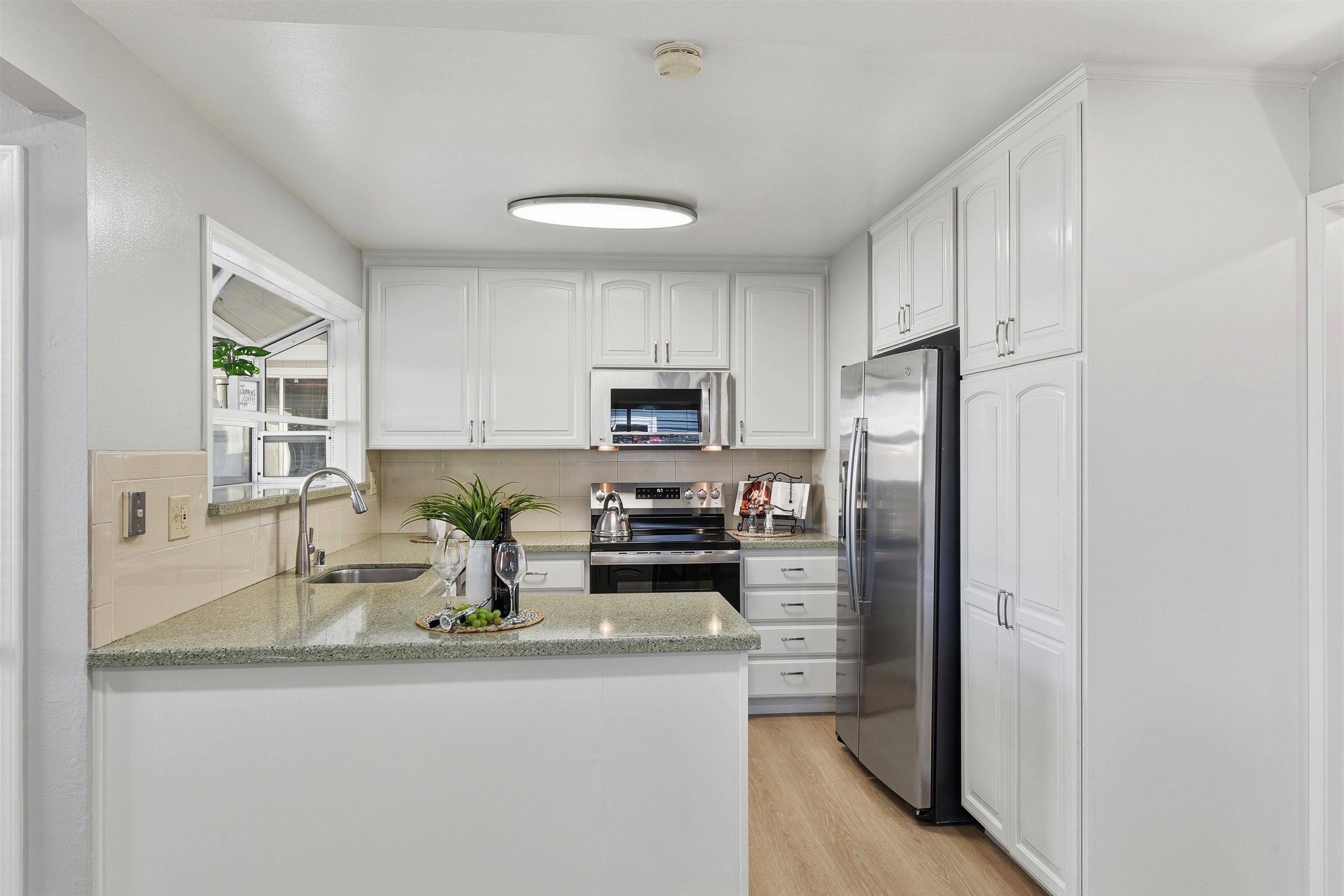 37768 Rockspray Street Newark, CA 94560 - Photo 7 of 34 a kitchen with stainless steel appliances granite countertop a refrigerator a stove a microwave and cabinets