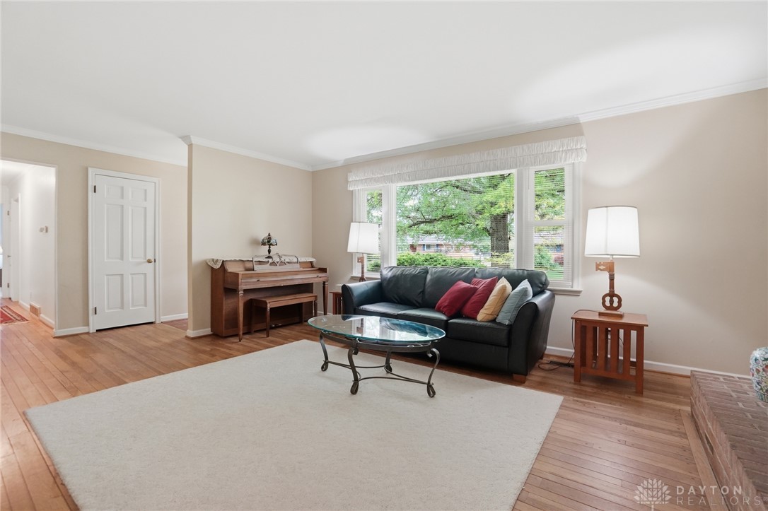 6119 Flemington Road Dayton, OH 45459 - Photo 6 of 76 This living area features a bright window and hardwood flooring, creating a warm and inviting atmosphere.