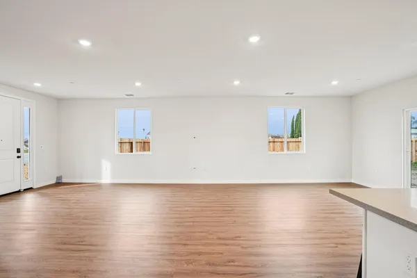 a view of empty room with wooden floor and fireplace